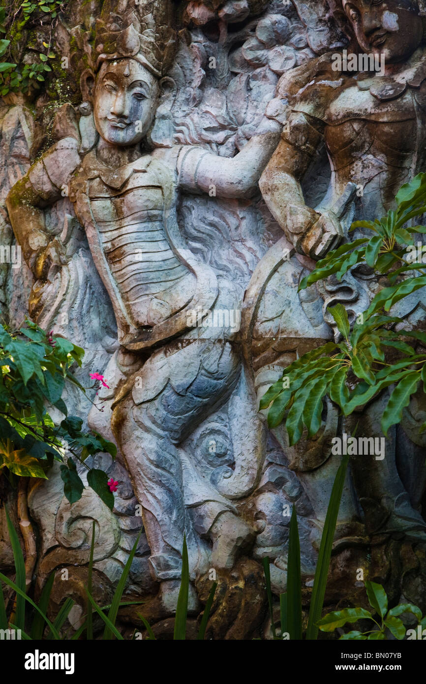 Wall carving at Puri Saren, Ubud Palace with natural growth and moss Stock Photo