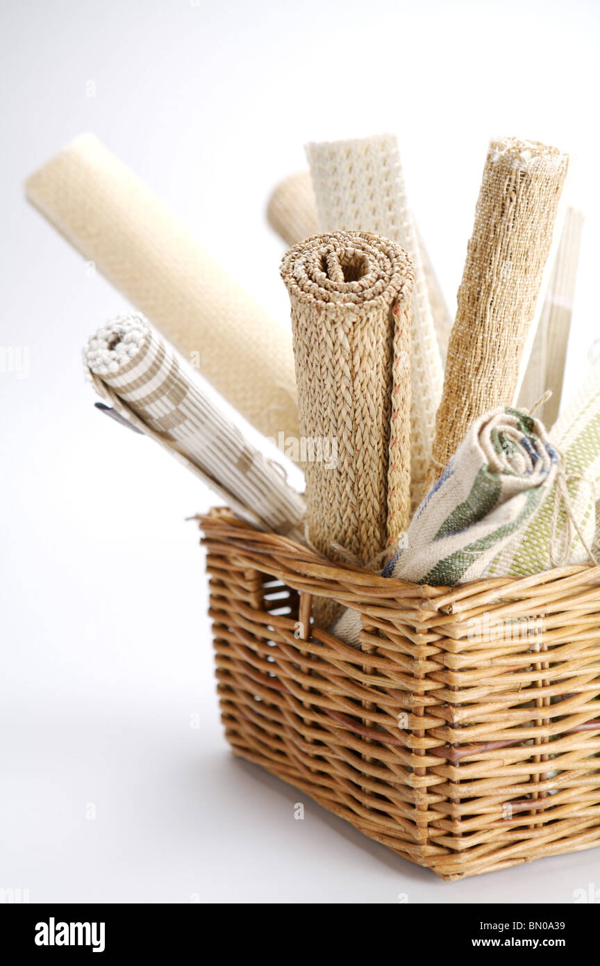Rolls of rugs in a basket Stock Photo Alamy
