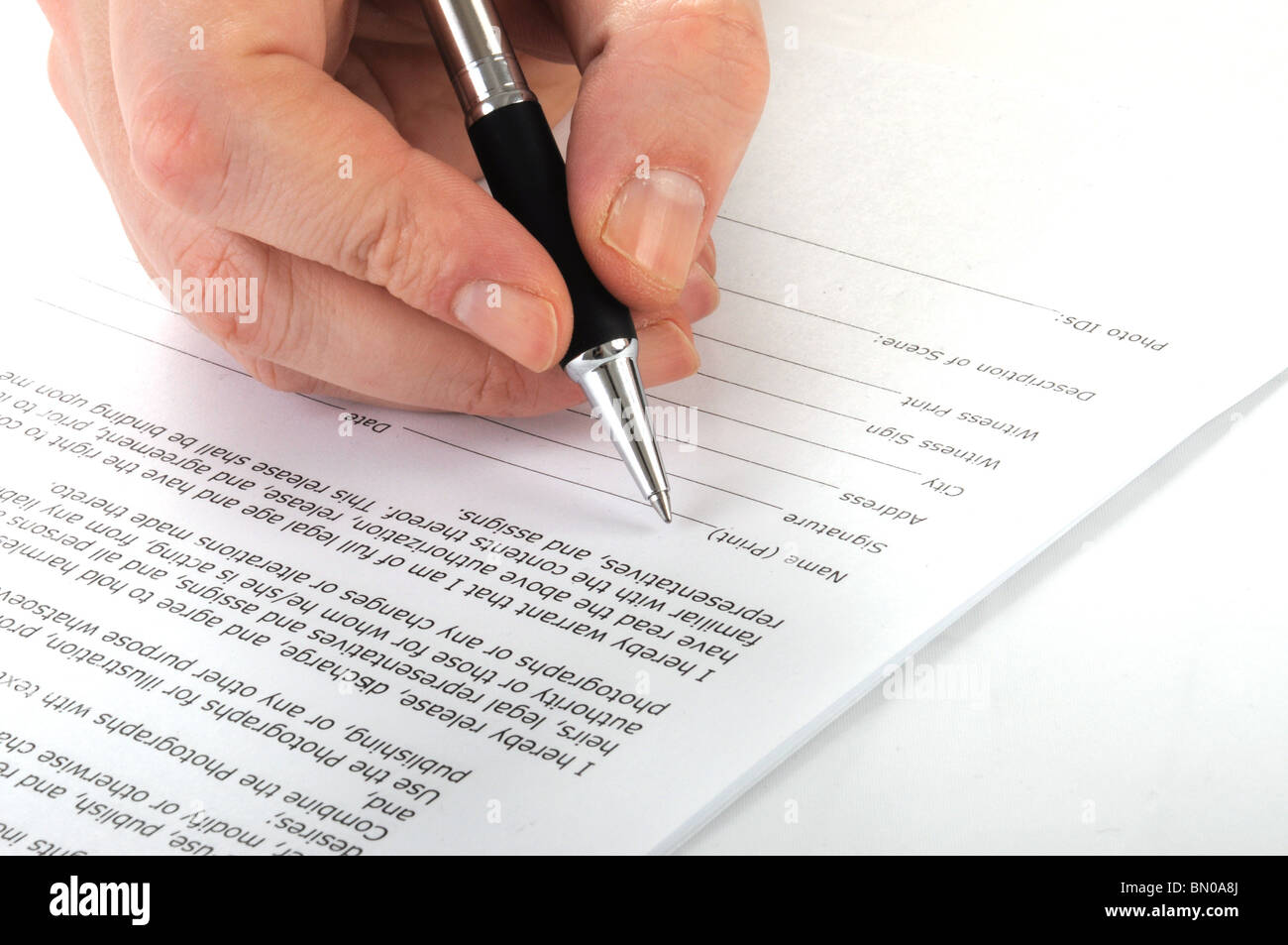 man is signing a contract with pen, isolated on white Stock Photo