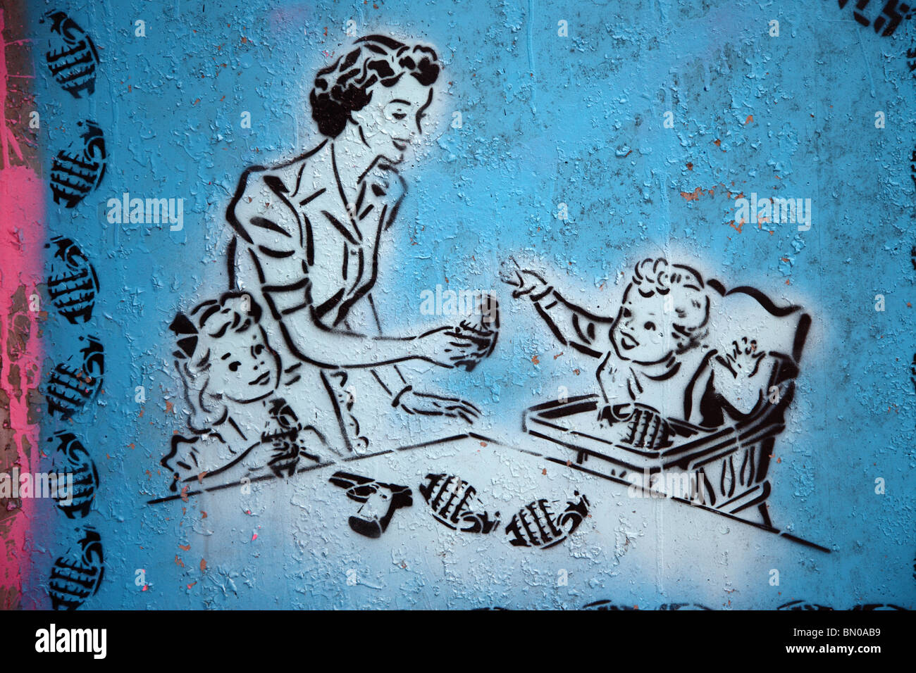 Graffiti showing 1950s style mother with young children and grenades in Leake Street, South Bank, Waterloo, London SE1. Stock Photo