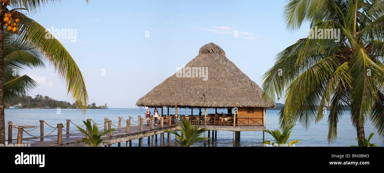 Beach Bar on jetty Playa Tortuga with tourists and palm trees Stock Photo