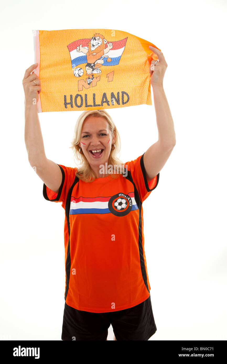 Dutch female soccer supporter in orange outfit holding flag ready for the match over white background Stock Photo