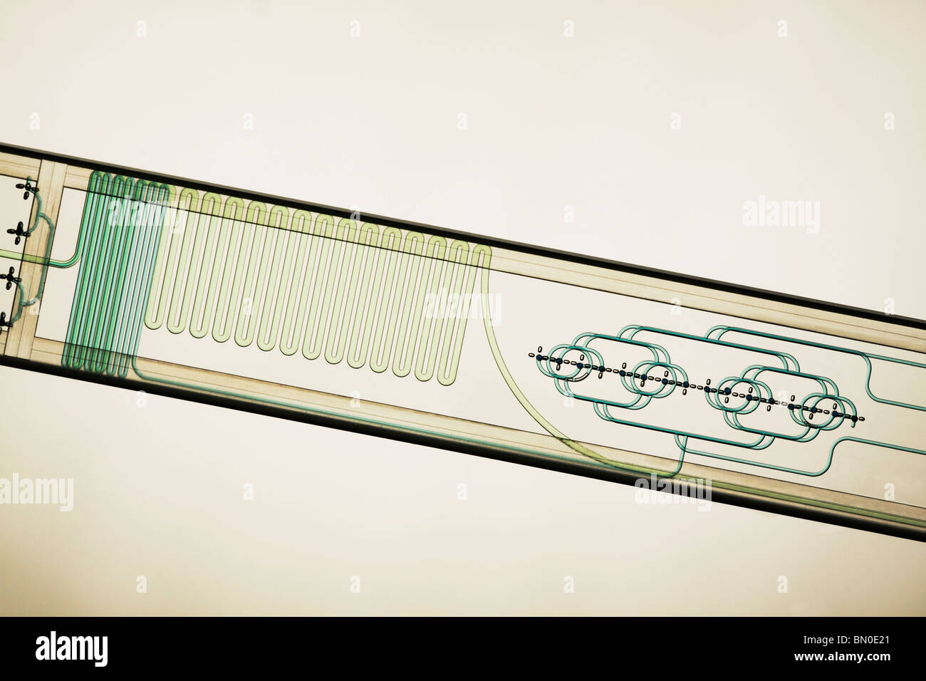 Microfluidic etched glass microreactor chip mixing mutiple fluid streams of liquids in micro and nano technology applications Stock Photo