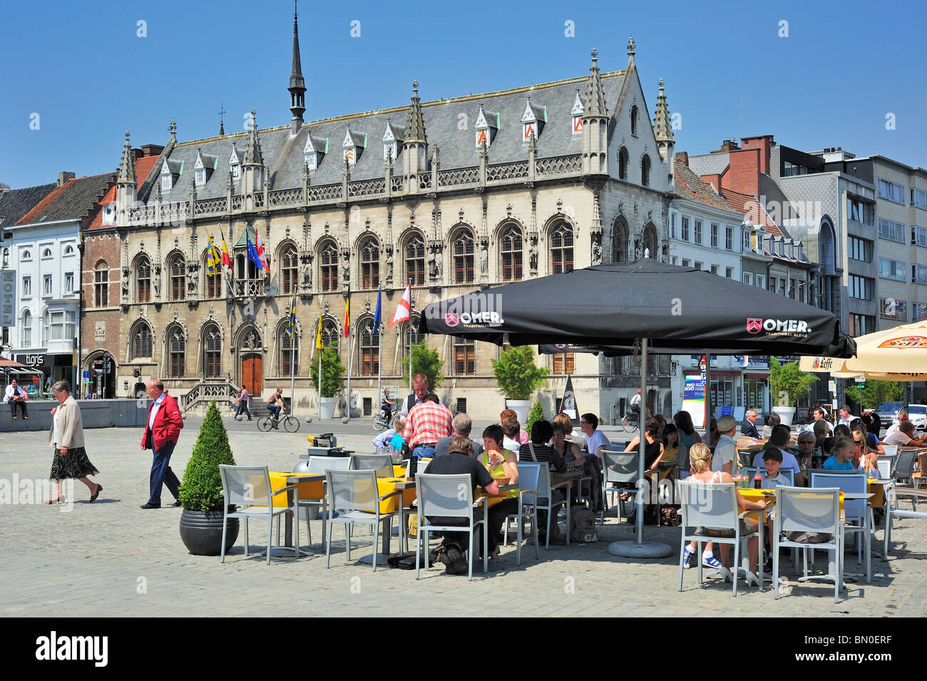 City Hall and tourists enjoying a drink at pavement café on the main square, Kortrijk, Belgium Stock Photo