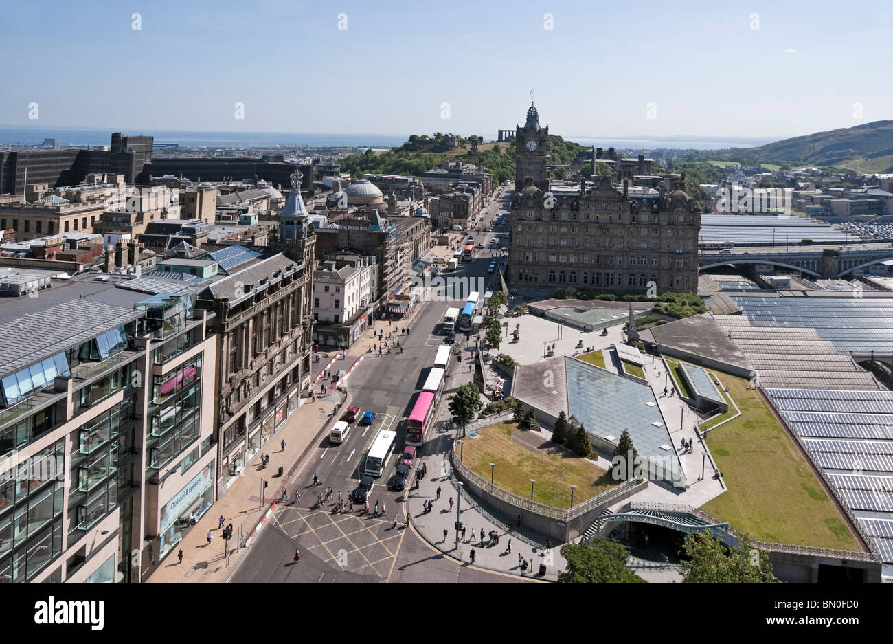Looking east from the Sir Walter Scott Monument along Princes Street towards the Balmoral Hotel centre and Calton Hill behind Stock Photo