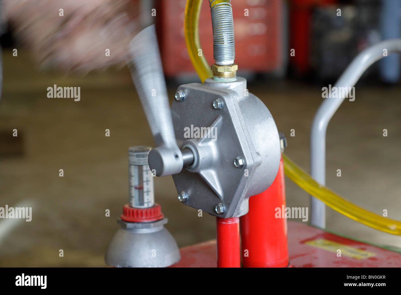 Hand operated pump to remove gasoline from tank of vehicle Stock Photo