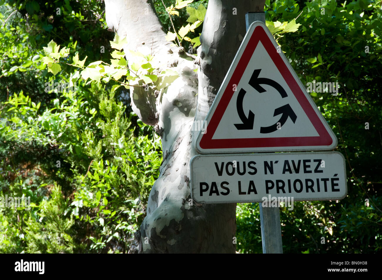 A French road sign warning that you do not have priority at a roundabout. Stock Photo
