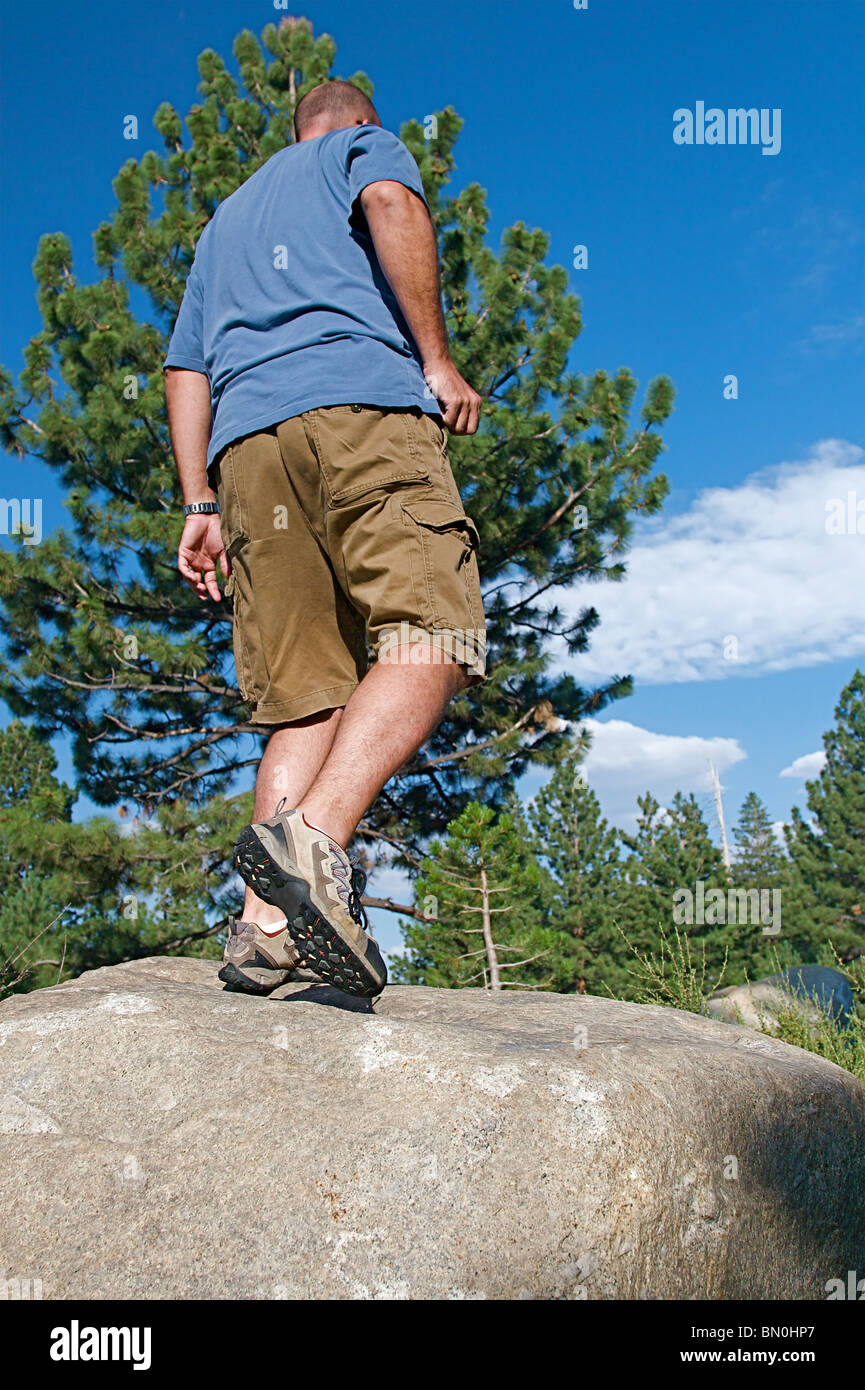 Trail runner climbing a steep rock in his path Stock Photo Alamy