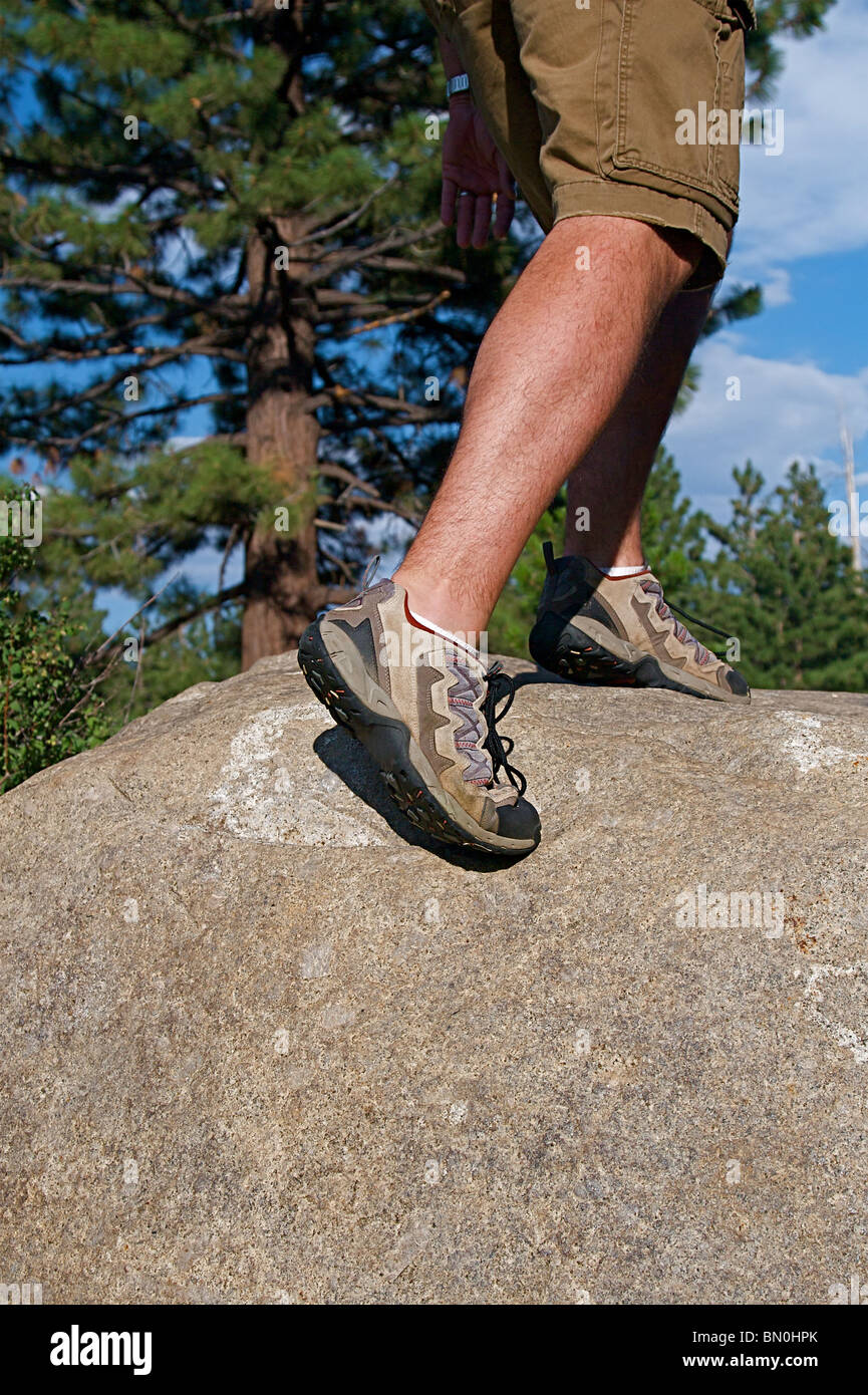 Trail runner climbing a steep rock in his path Stock Photo Alamy