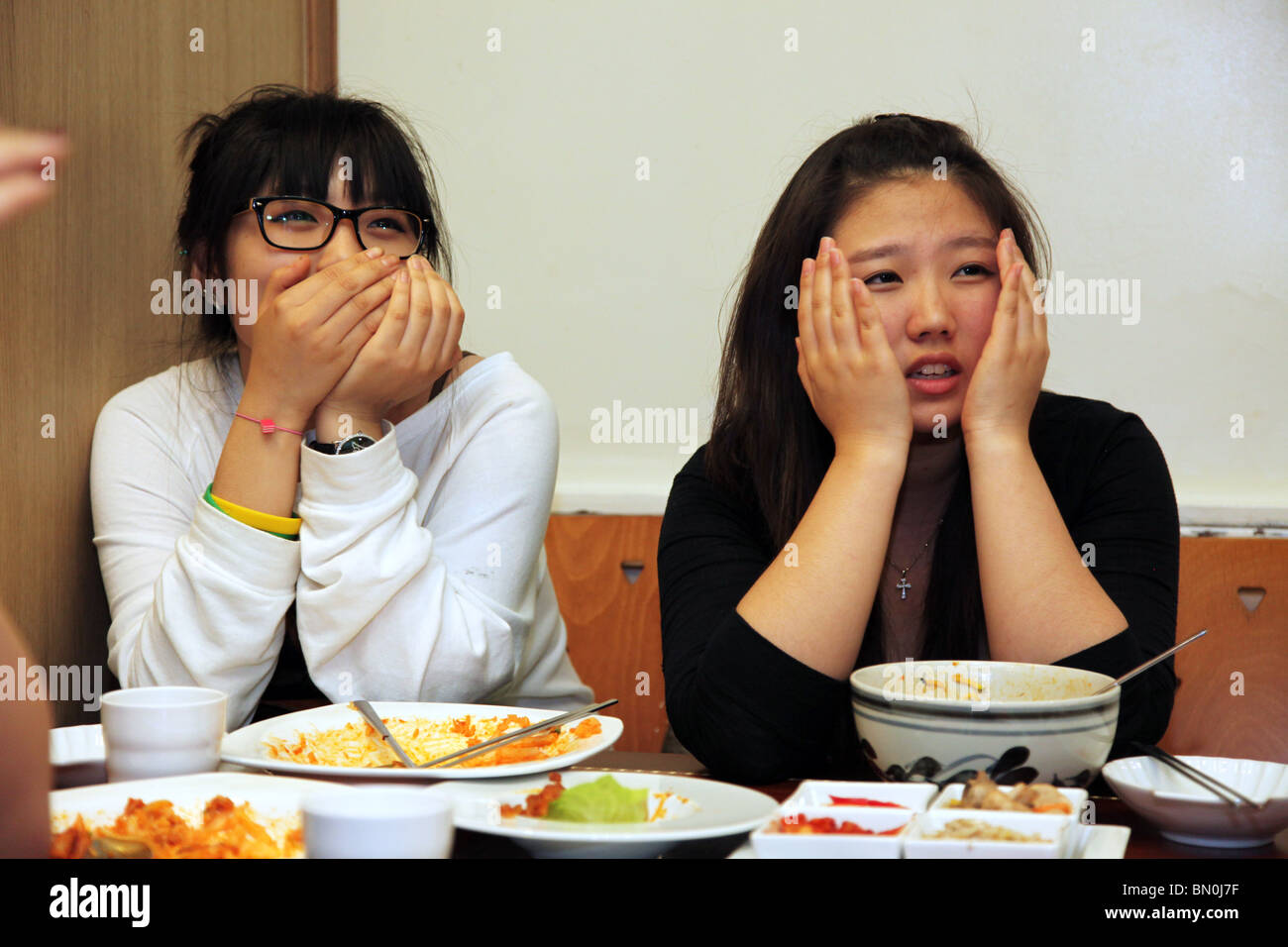 South Koreans watch their country compete in 2010 world cup, in a restaurant in London. Stock Photo