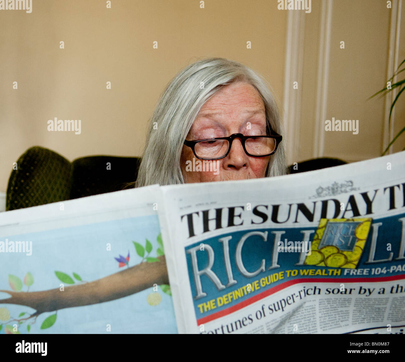 A lady reading the Sunday Times Stock Photo Alamy