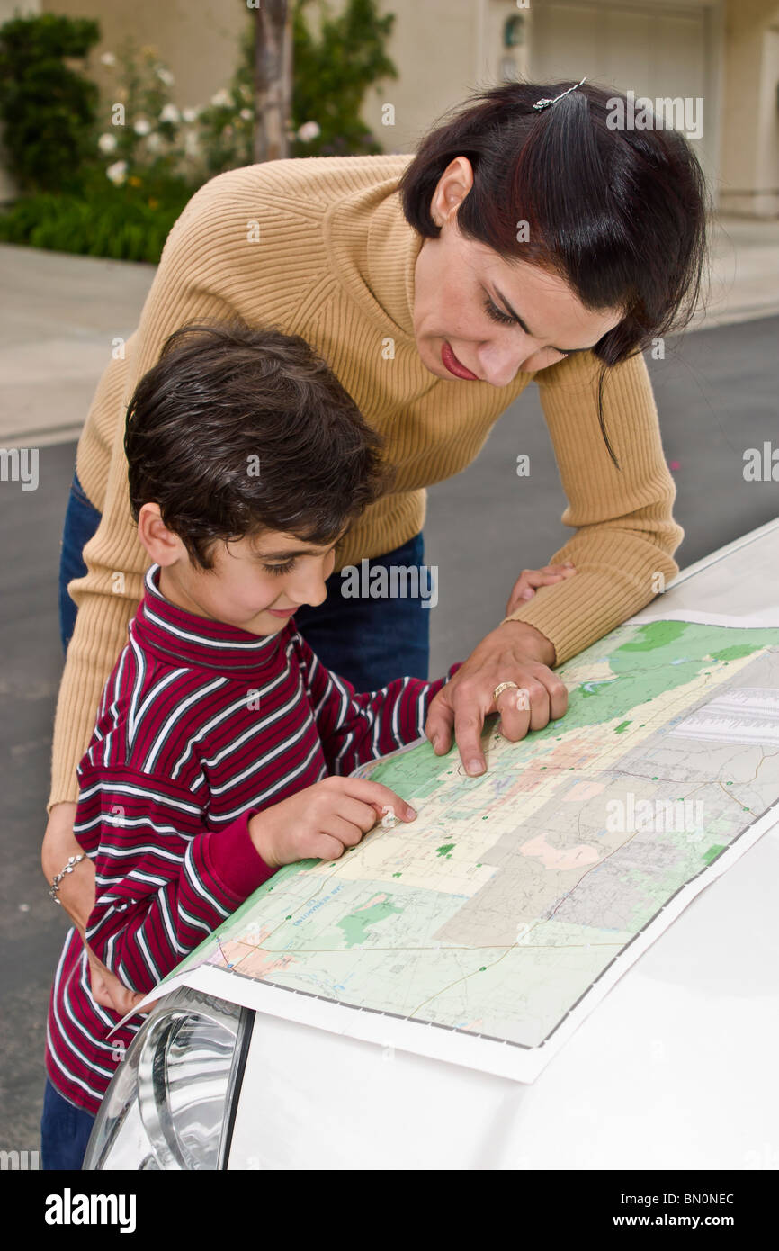 multi racial diversity racially diverse multicultural cultural Persian 5-7 years old studies map son determine route children reading  person people Stock Photo