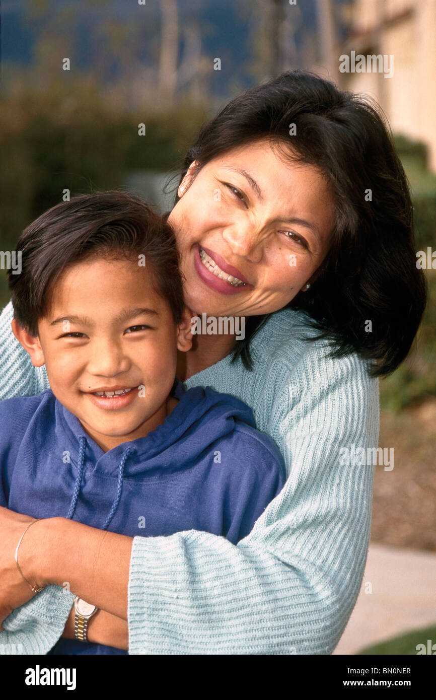 multi ethnic inter racial diversity racially diverse multicultural  cultural interracial Filipino mom hugs 9 year old son. MR©Myrleen Pearson Stock Photo