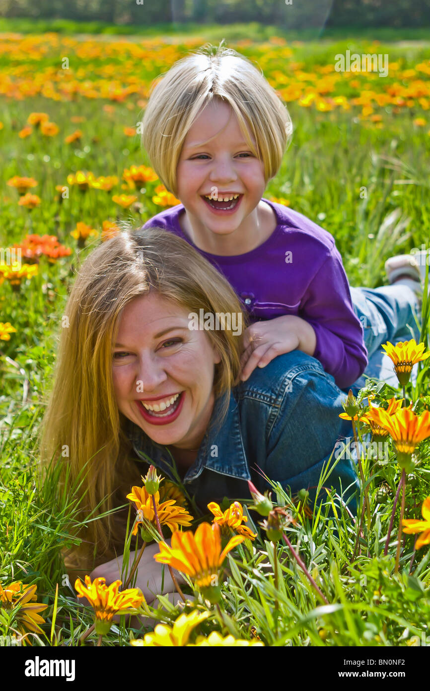 Caucasian Young playing mother n flower field with 3-4 year years old daughter. children having fun United States MR  © Myrleen Pearson Stock Photo