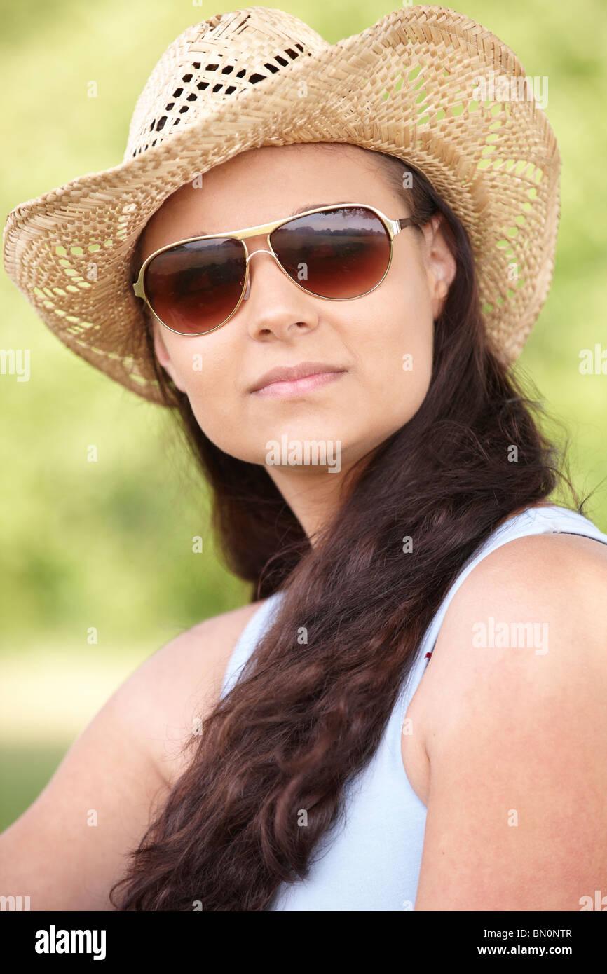 young woman sitting on grass in park enjoying the sunshine Stock Photo ...