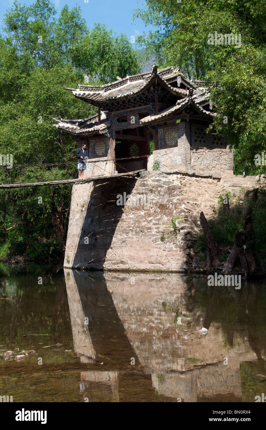 Man fishing from wooden bridge Shiguzhen Yunnan China Stock Photo
