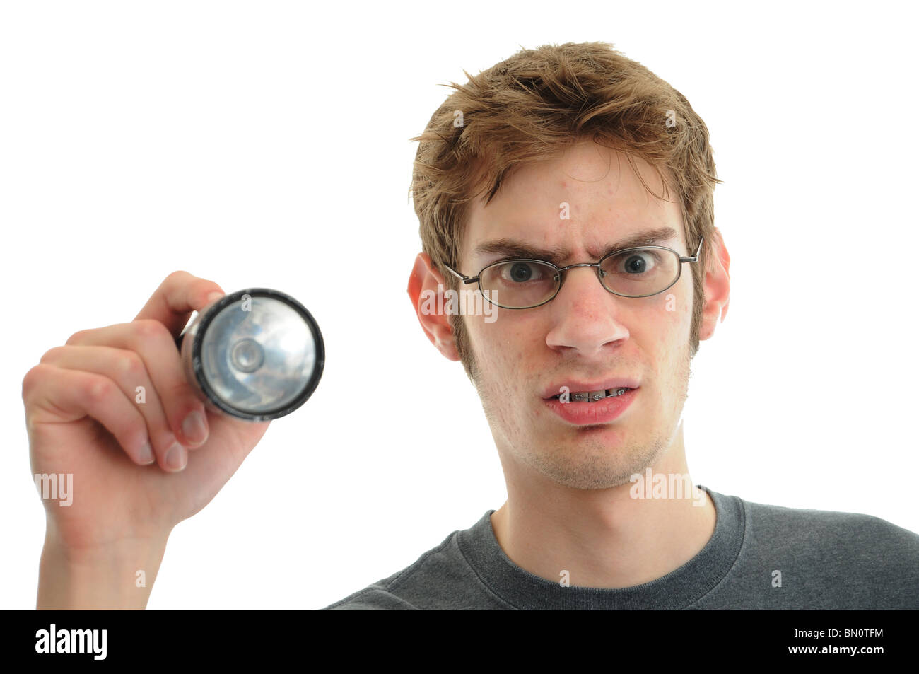 A young white Caucasian repair man with flashlight isolated on white Stock Photo