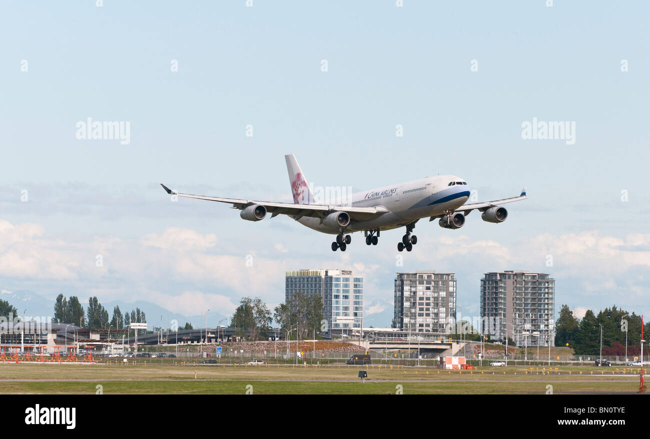 A China Airlines Airbus A340 on final approach for landing at Vancouver International Airport (YVR). Stock Photo