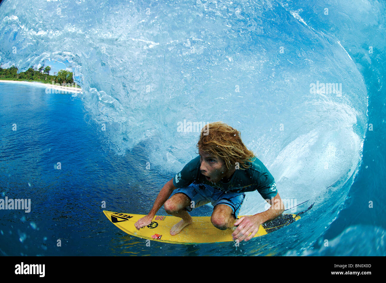 Surfer in the tube of large wave Stock Photo