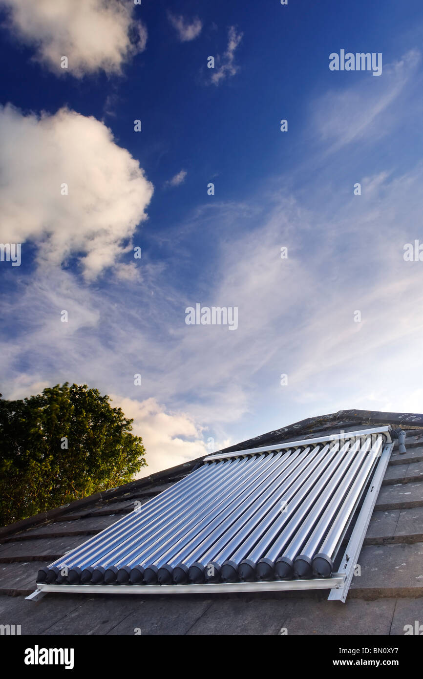 Solar Power. Solar vacuum/evacuated tubes on a domestic house roof in the UK Stock Photo