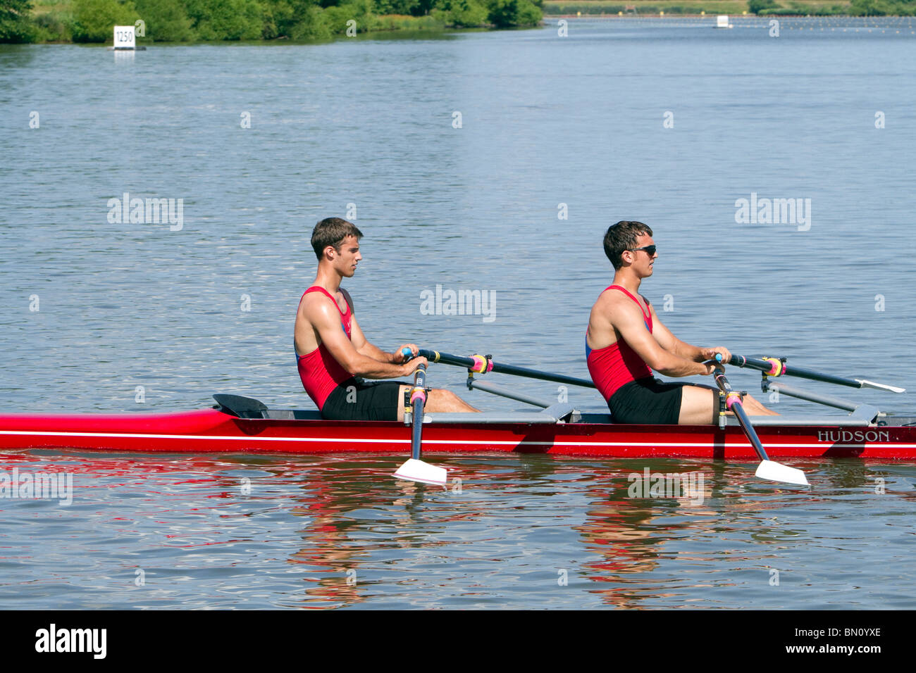 Two man racing shell boat with crew rowing Stock Photo