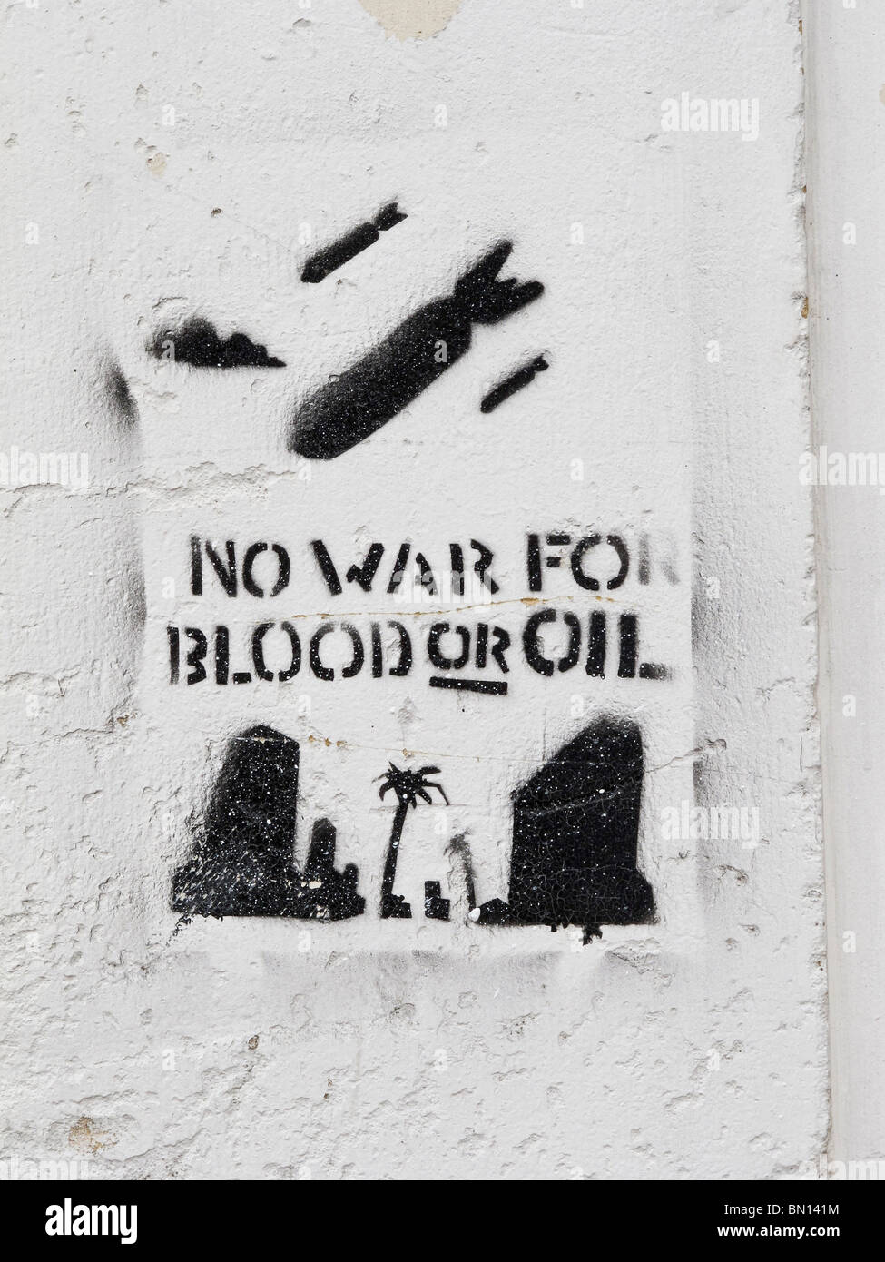 A sprayed on grafitti type sign saying 'no war for blood or oil'. Stock Photo