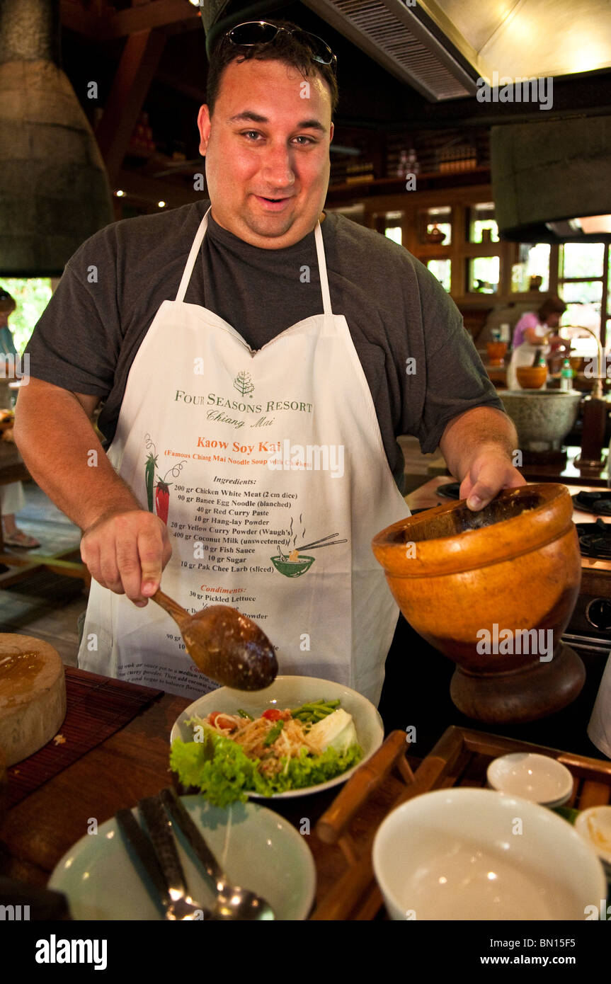 Learning to cook Thai food at the Four Seasons Resort cooking class in Chiang Mai, Thailand. Stock Photo