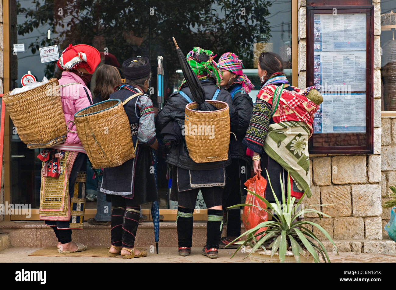 Local woman hawkers outside a restaurant in a market in Sapa, north west Vietnam Stock Photo