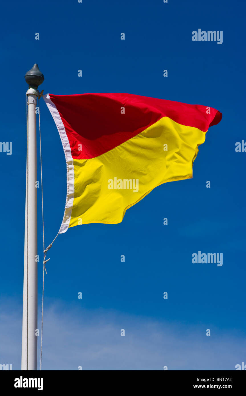 UK Red And Yellow Beach Flag Lifeguard on duty Stock Photo