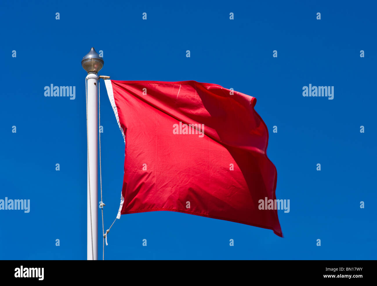 UK Red Warning Beach Flag Danger do not enter the water Stock Photo