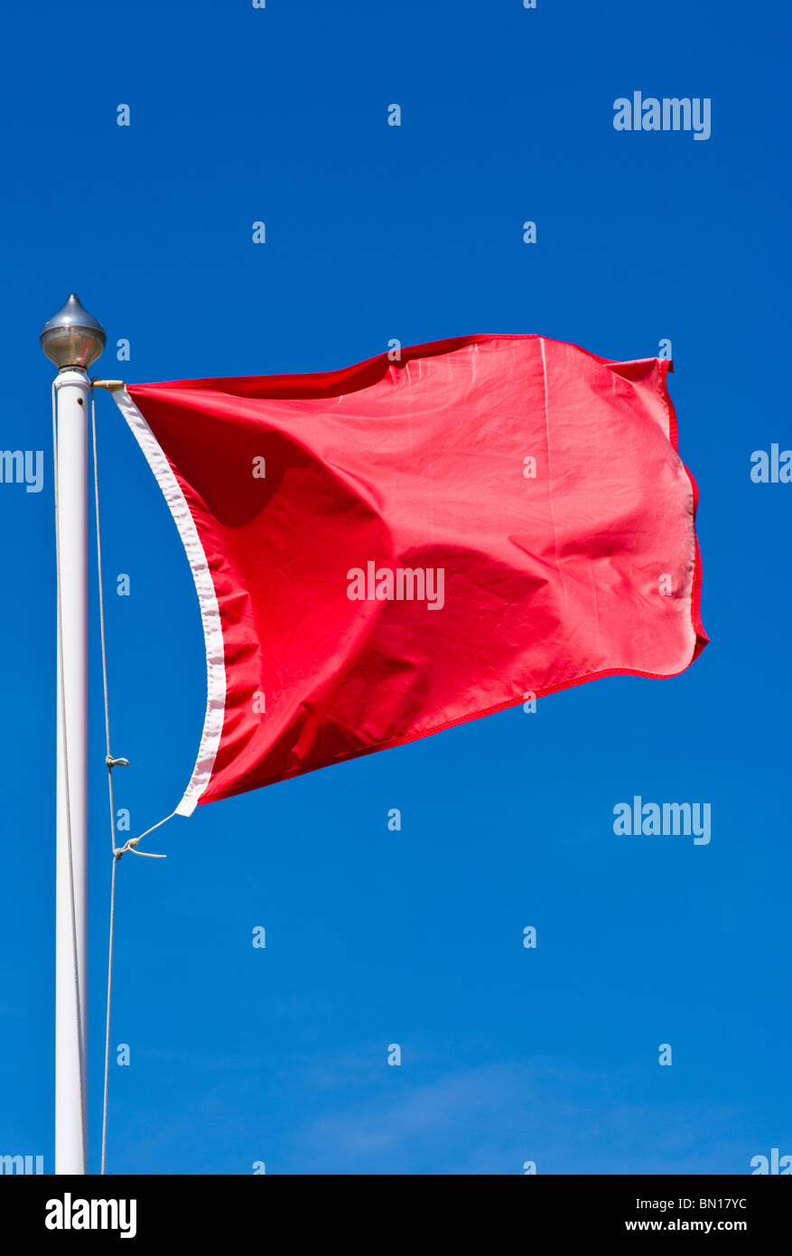 UK Red Warning Beach Flag Danger do not enter the water Stock Photo