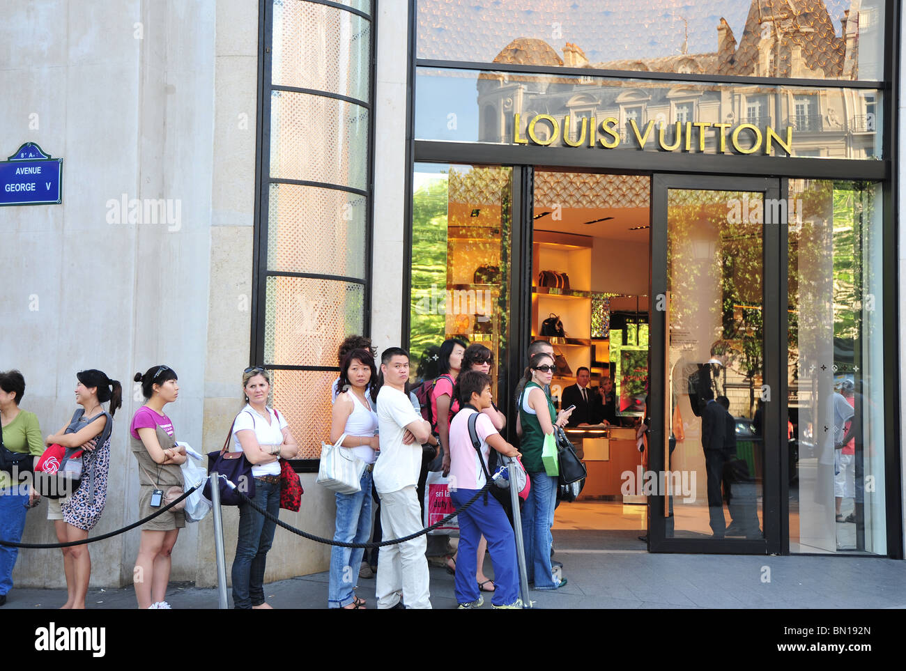 Japanese tourists queuing at Louis Vuitton store in Champs Elysees, Paris,  France Stock Photo - Alamy