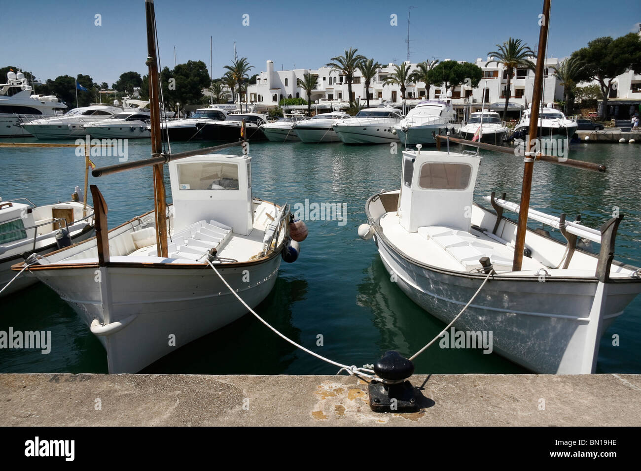 Traditional Mallorcan fishing boats moored in Cala D'or harbour Stock Photo