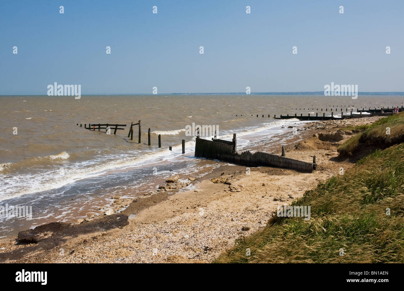 An old wooden breakwater on Leysdown Beach on the Isle of Sheppey in Kent.  Photo by Gordon Scammell Stock Photo