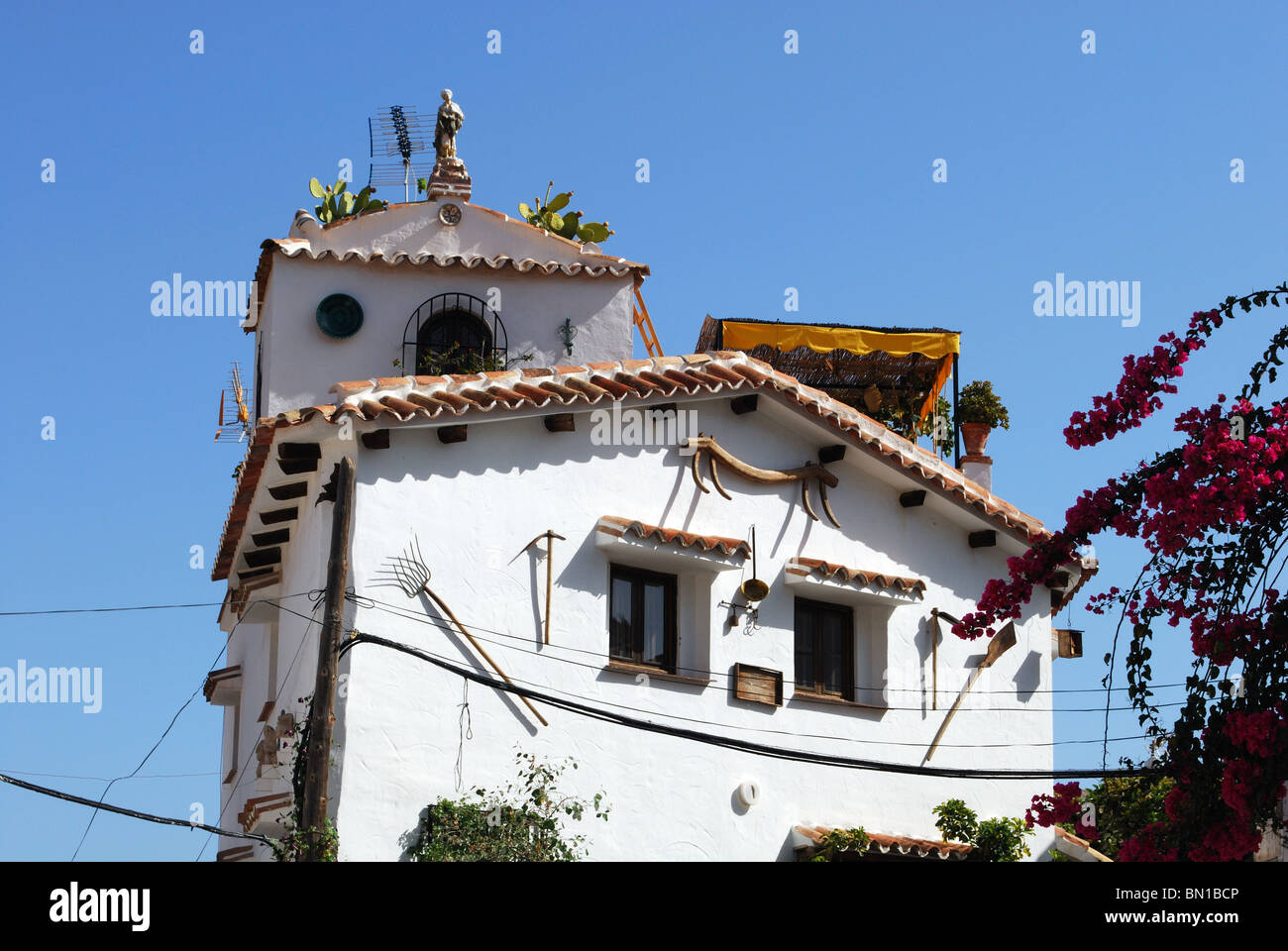 Unusual village house, whitewashed village (pueblo blanco), Macharaviaya, Costa del Sol, Malaga Province, Andalucia, Spain. Stock Photo