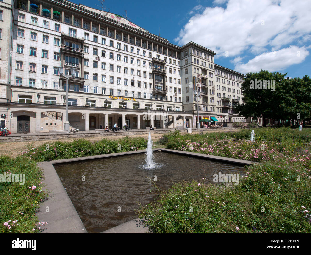 Fountain in front of historic old apartment building on Karl Marx Allee in former East Berlin in Germany Stock Photo