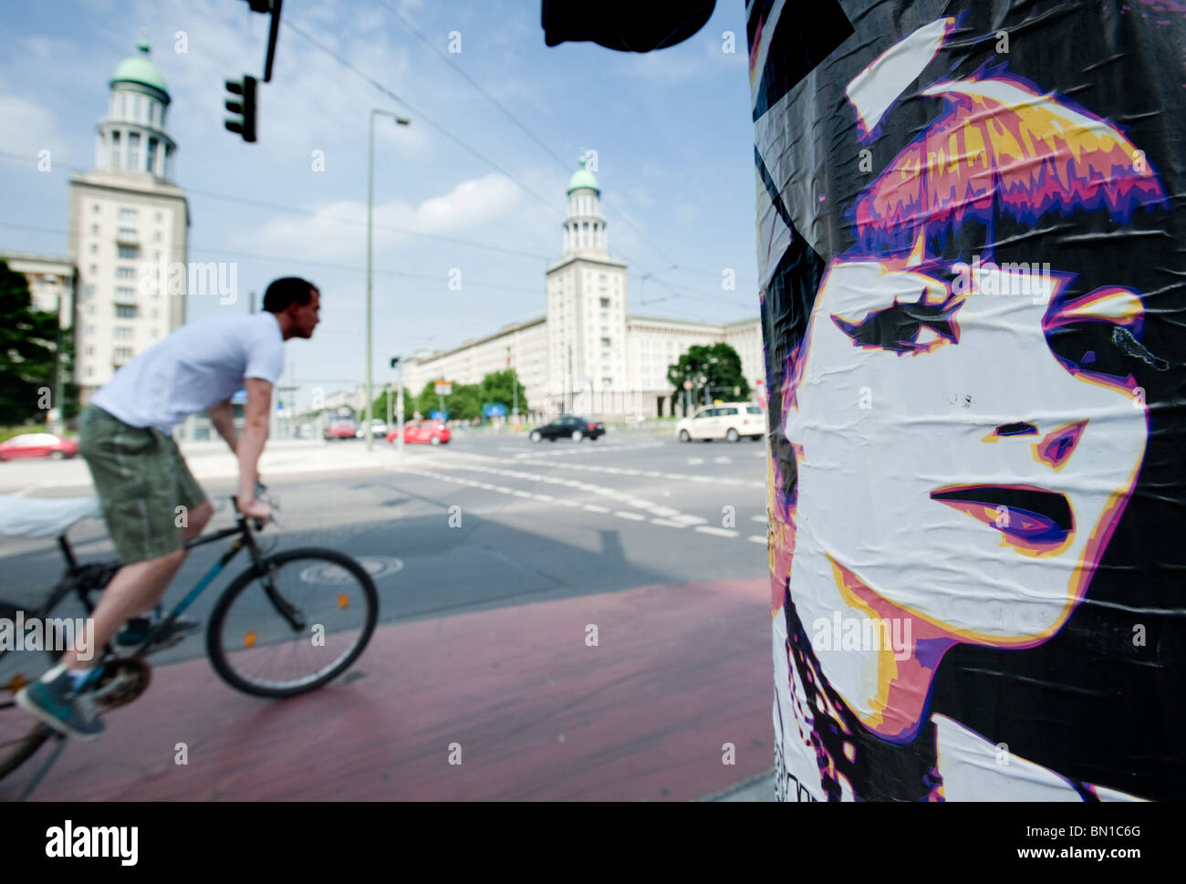 View of Frankfurter Tor on Karl Marx Allee with pop poster foreground in former East Berlin Germany Stock Photo