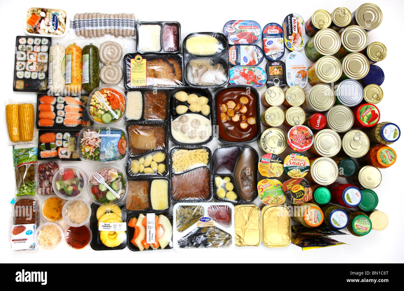 Selection of convenience food. Fresh salads, fruits, meats, soups and pasta dishes in cans, read-to-serve meals, vegetables. Stock Photo