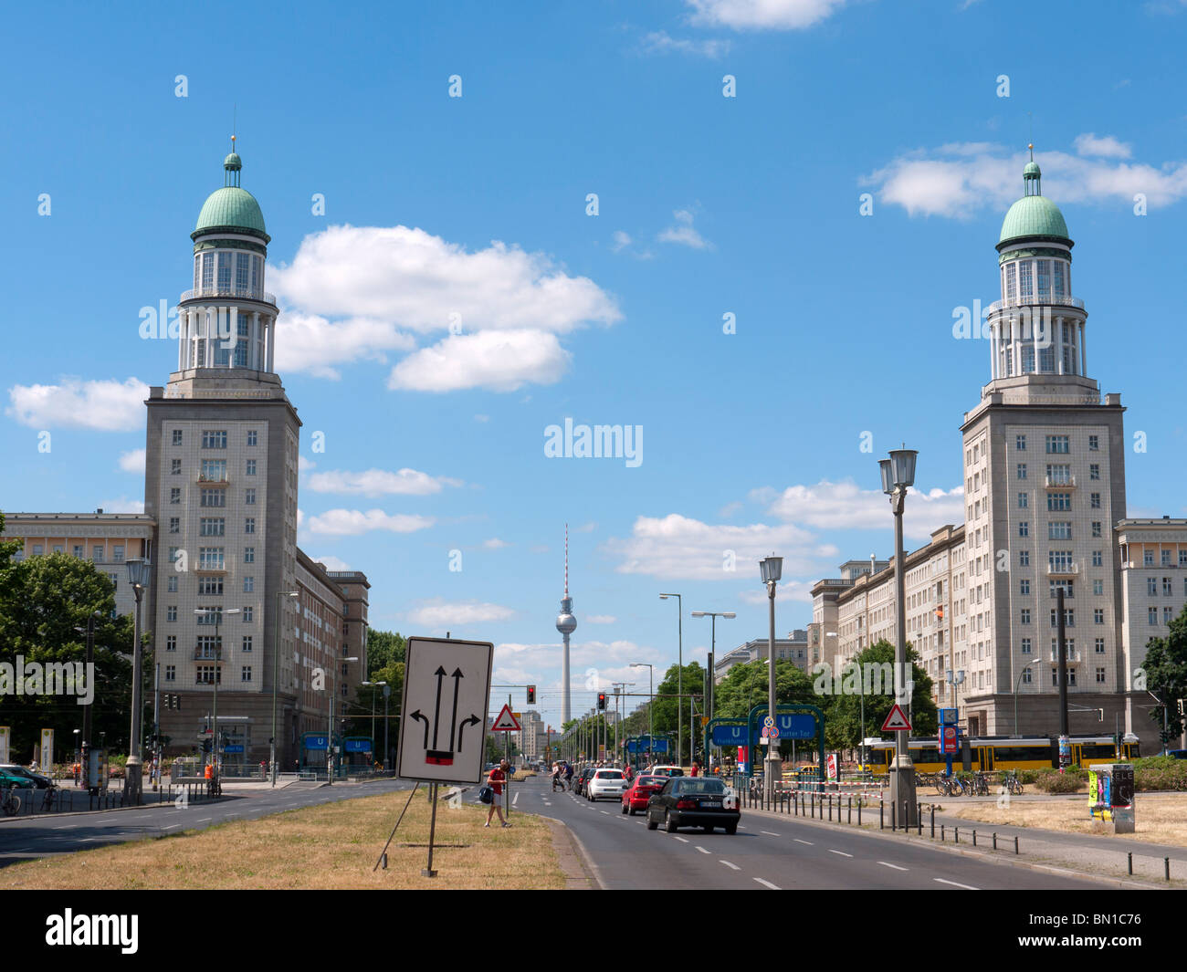 View of Frankfurter Tor historic landmark with TV Tower to rear on Karl Marx Allee in former East Berlin Germany Stock Photo