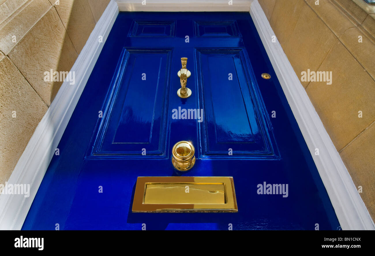 An imposing fresh blue Georgian front door with polished brass fittings London England UK Stock Photo