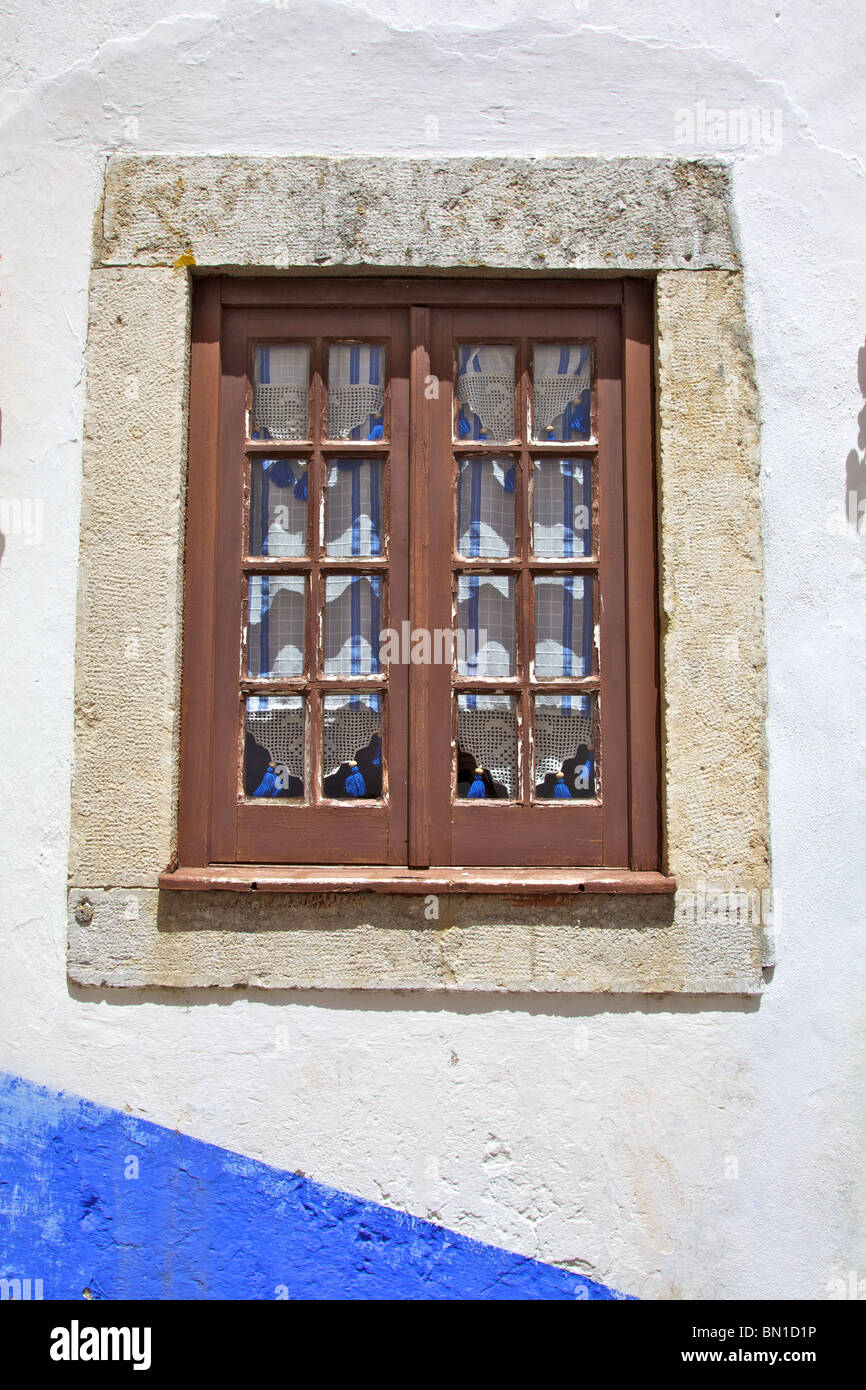 Rustic Brown Wood Window against a Blue Wall Stock Photo