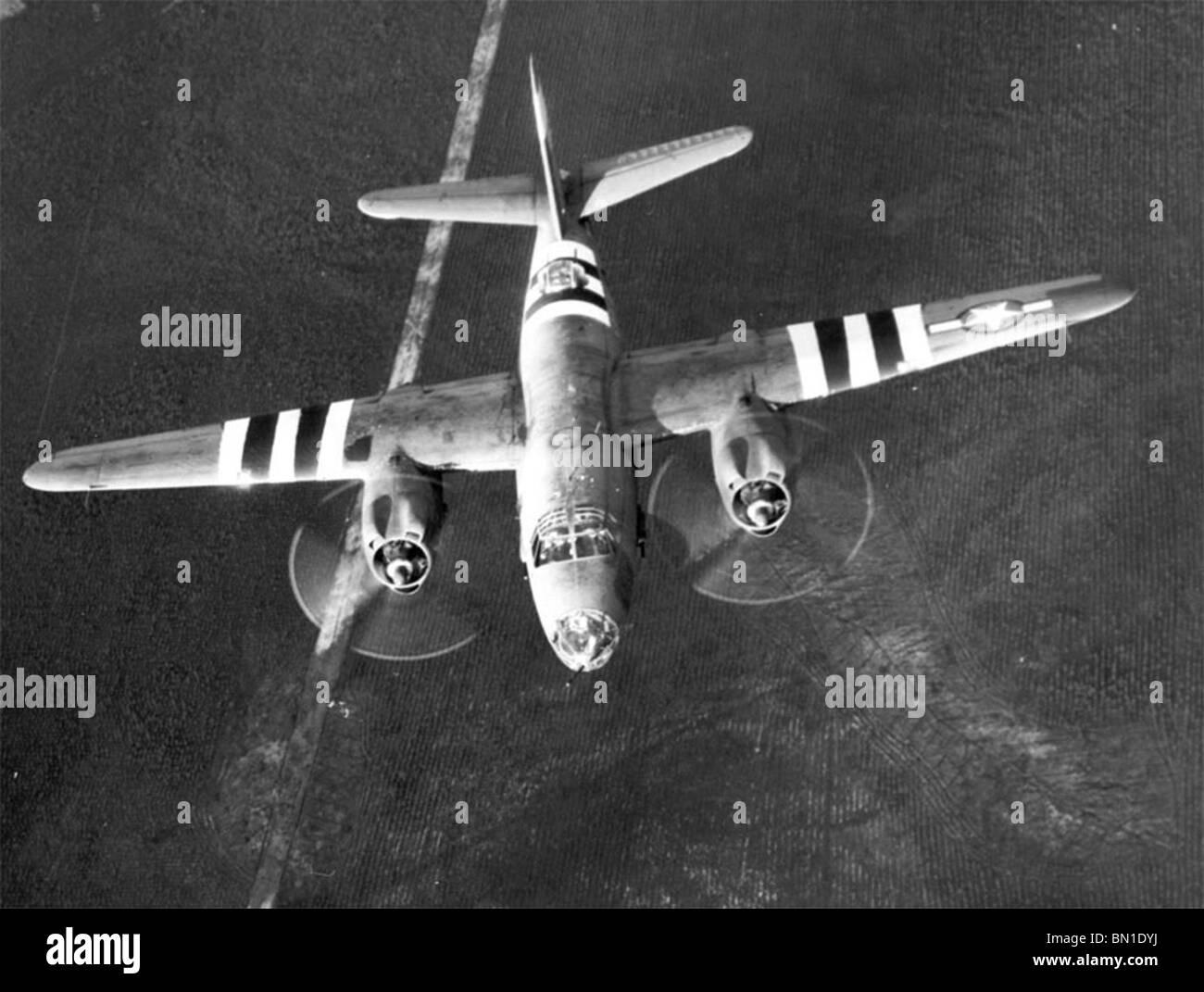 A B-26 Marauder flies with invasion stripes for D-Day. Stock Photo