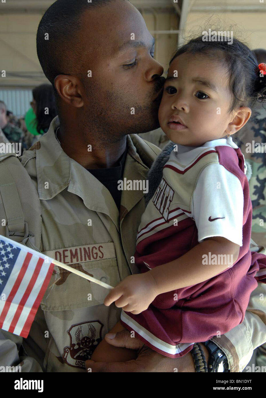 Tech Sgt. Kenyatta Demings kisses his 19-month-old daughter Myka, after returning home Oct. 23 from a deployment to Afghanistan Stock Photo