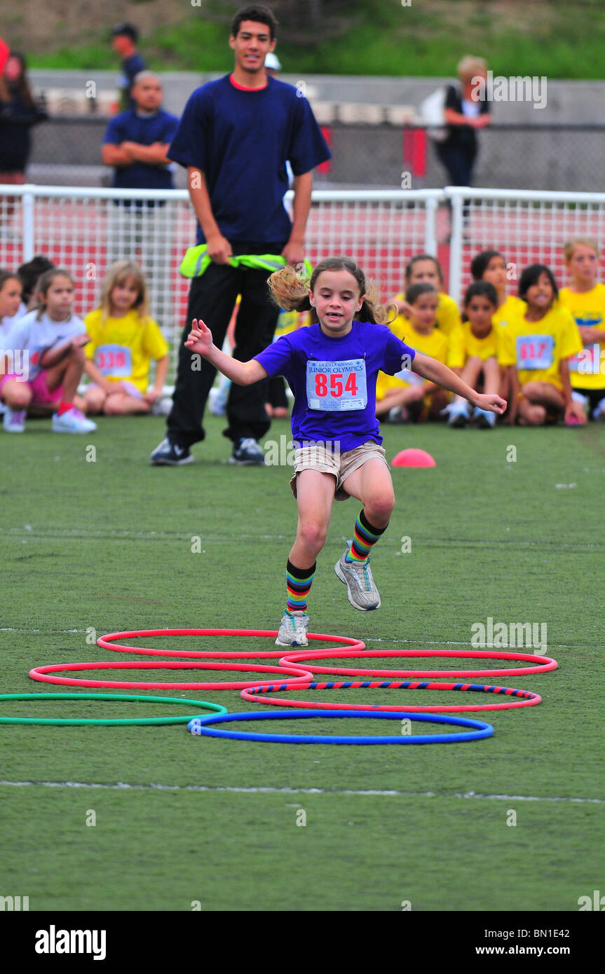 Young girl competes in obstacle course at Junior Olympics in La Jolla California USA - Stock Image