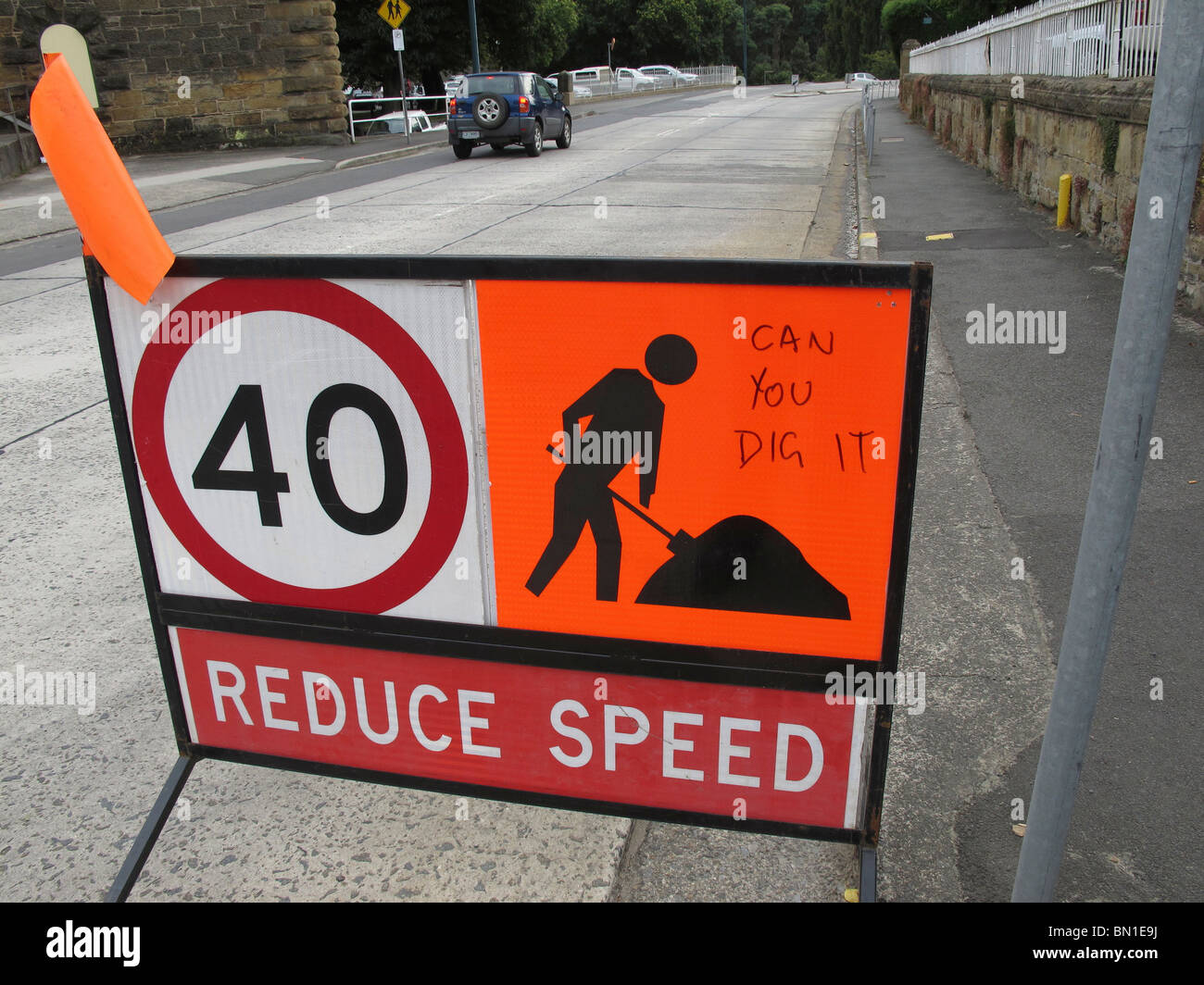 Road work sign with speed limit and graffiti Stock Photo