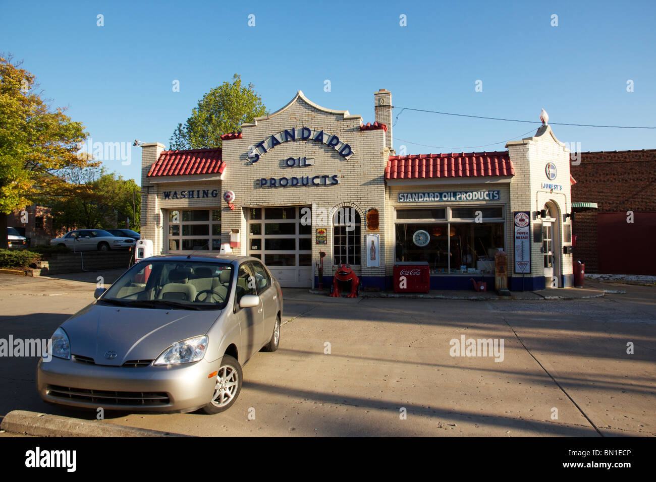 Historic Standard Oil filling station with first generation Toyota Prius parked in front. Lafayette, Indiana Stock Photo