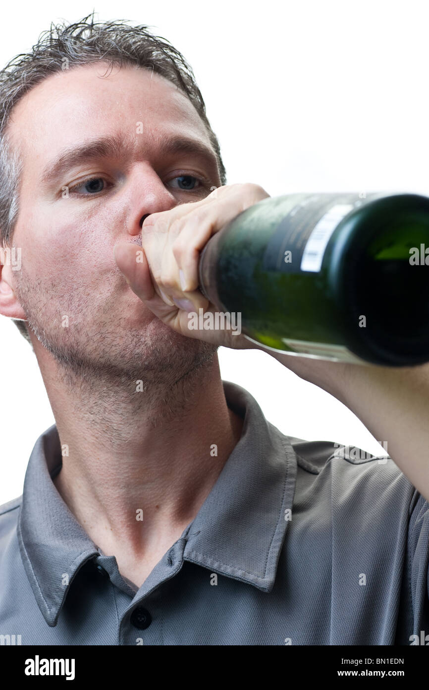 A man drinking from a wine bottle, isolated on white. Stock Photo