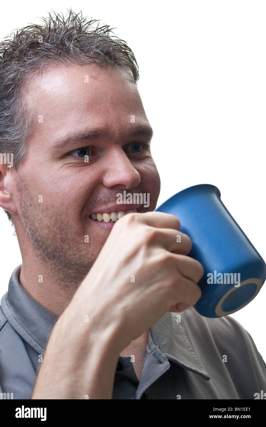 A closeup of the upper body of a man, ready to take a drink from his coffee cup, isolated on white. Stock Photo