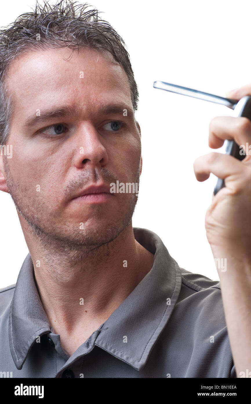 A man folding closed a flip phone, isolated on white. Stock Photo