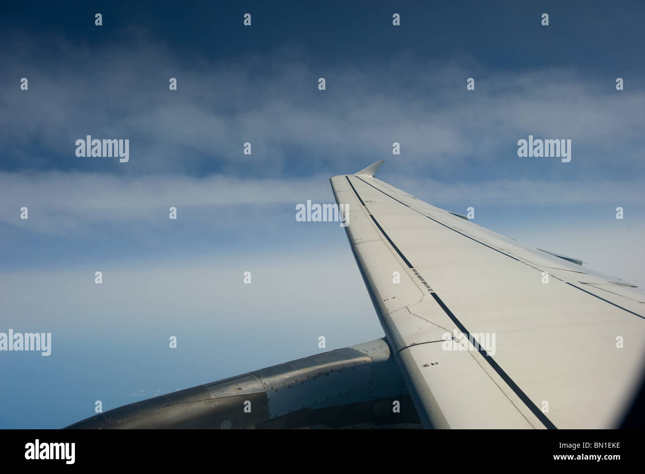 The view from the window of a passenger jet showing the engine and wing with a blue sky, Europe 2010 Stock Photo